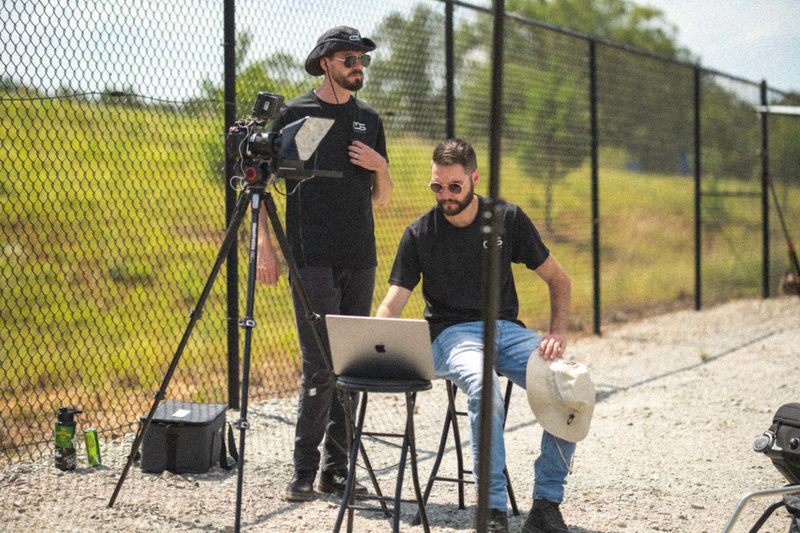 A shoot set up at the fence line, the subject on camera and the monitor on a stand