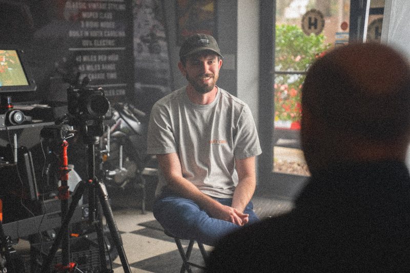 An interview set built in a motorcycle shop, camera framed on the subject
