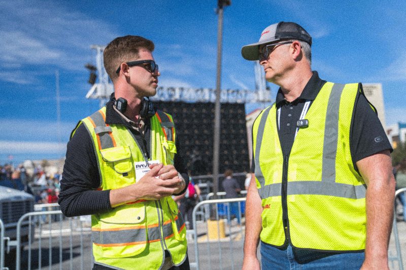 Two crew in high-vis talking through the next shot at the PaveX demo