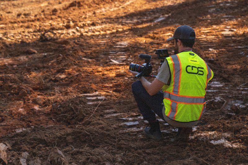 A CDS shooter down in the red clay filming at ground level