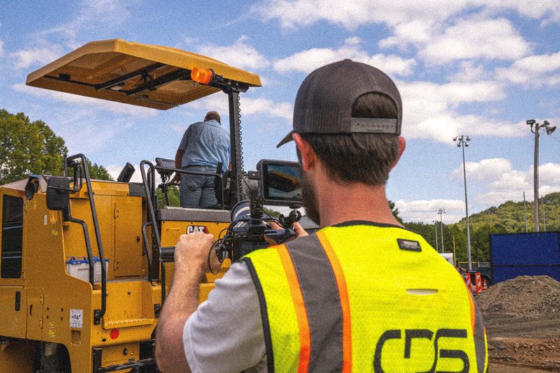Filming an operator in the cab of a wheel loader from the ground