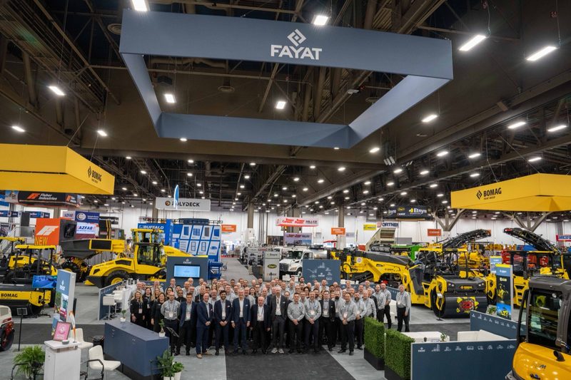 The full team posed across the stand under the FAYAT sign, machines lined up behind