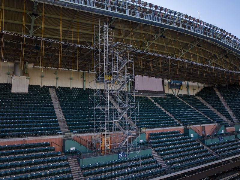 Scaffold tower climbing to the roof deck above the empty seating bowl