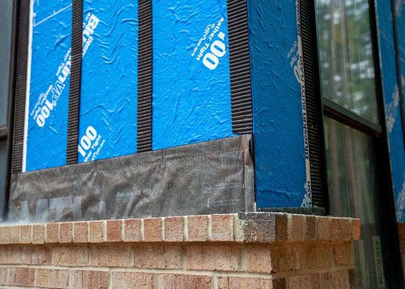 Close on the wall build-up, insulation board over the brick ledge at the window