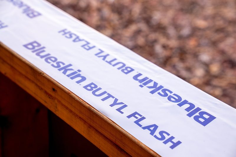 Macro on a roll of Blueskin butyl flashing laid along a framing member
