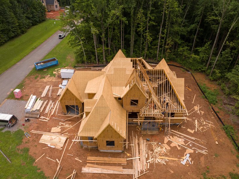 Aerial of the house at truss stage, roof framing open to the sky