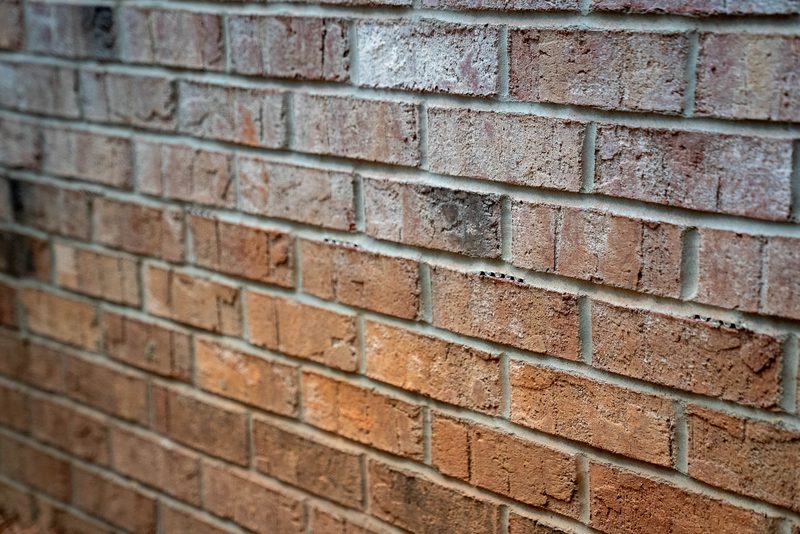 Close on the brick, mortar joints raked and the courses running out of focus