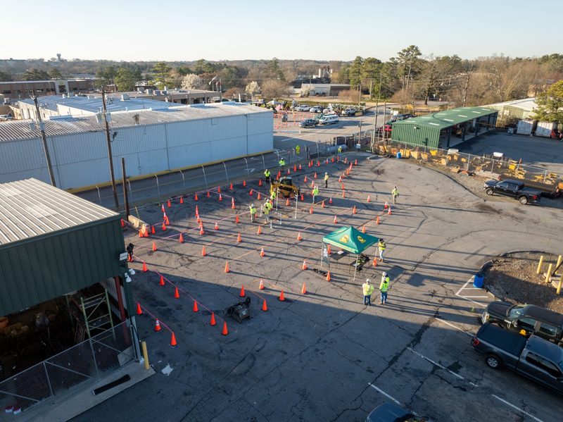 Elevated wide of the cone course marked out across the yard, crew spread along it
