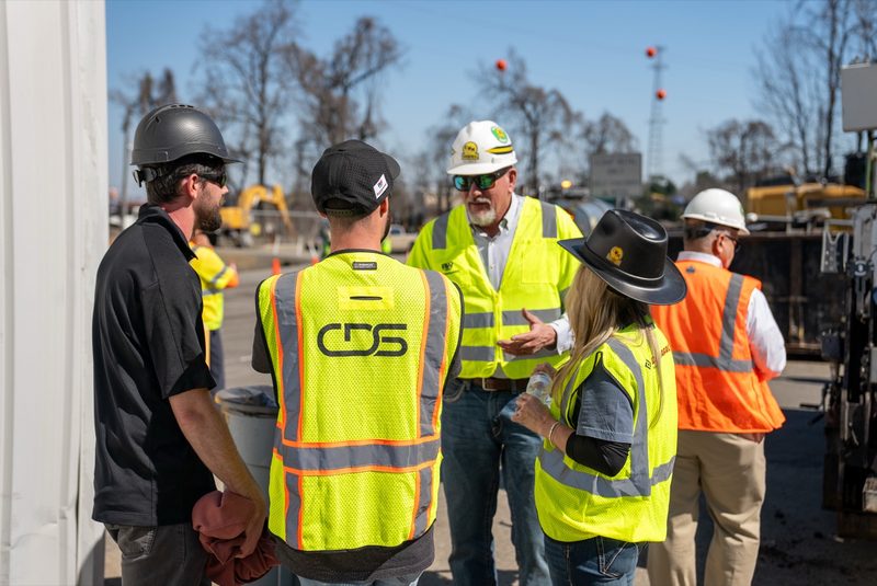 A huddle in high-vis between runs, one of our crew talking it through
