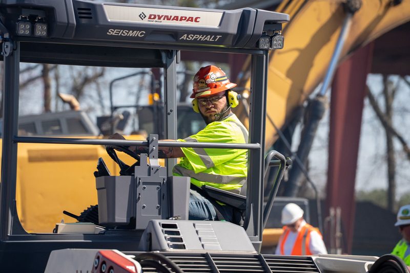 An operator settled into the cab of a Dynapac Seismic asphalt machine