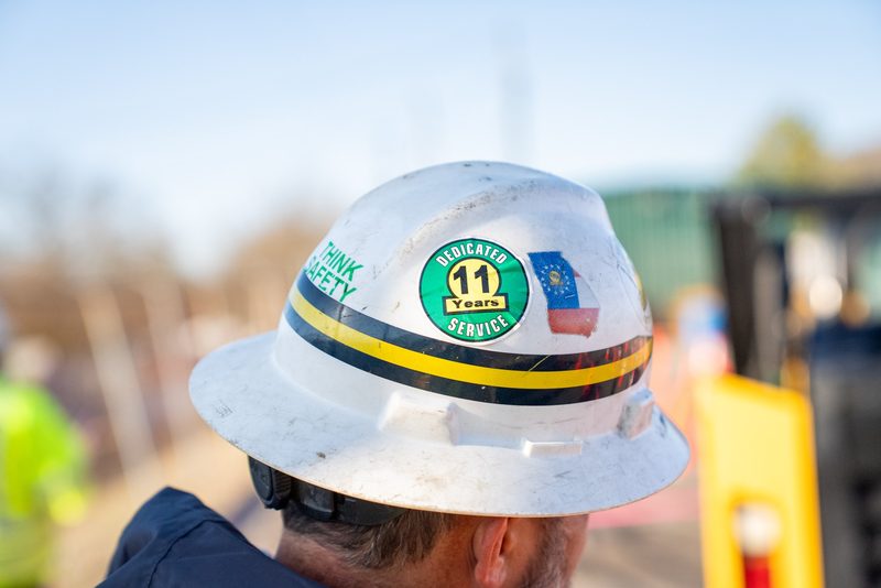 Close on a hard hat carrying an eleven-year service sticker