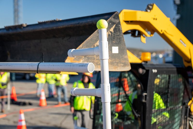 Machines staged on the course, crew in high-vis waiting their turn