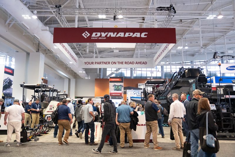 The Dynapac stand at the show, visitors moving among the machines under the banner