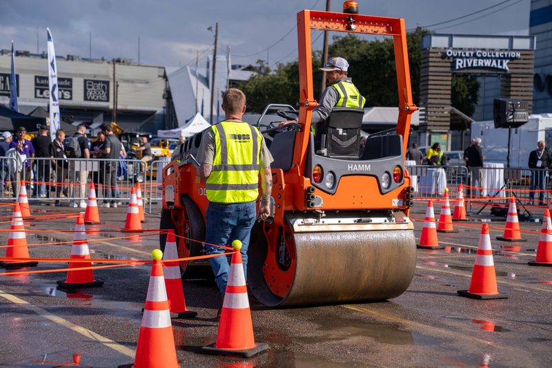 A HAMM roller running the outdoor demo, crew and cones holding the line