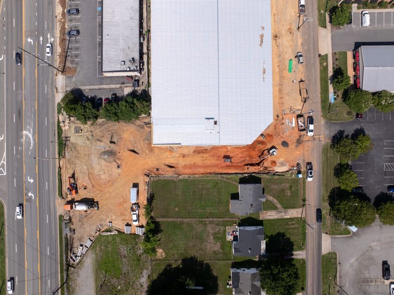 Straight down over the building pad, the road running past the site