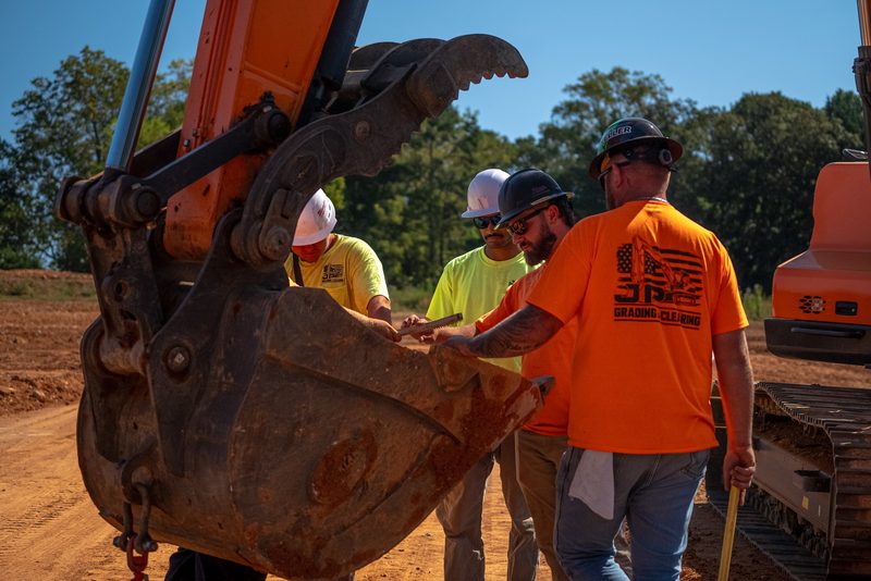Three of the crew talking it over at the bucket