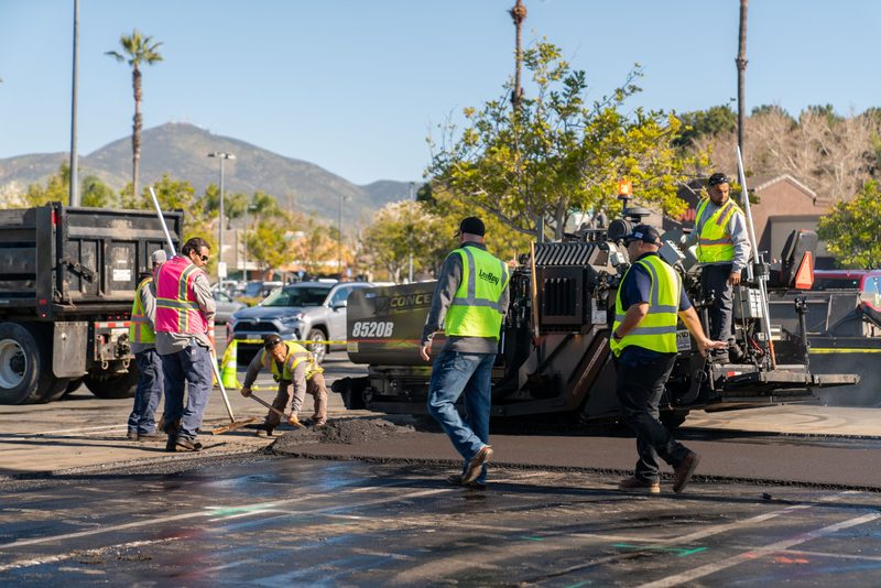 The paving crew working the mat behind an 8520C, mountains on the horizon