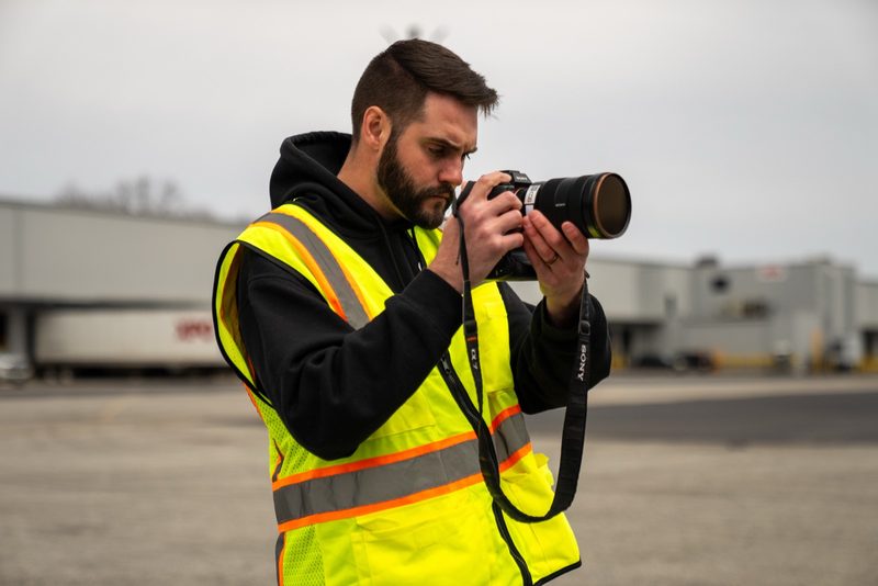 A shooter shooting stills in high-vis on the pour