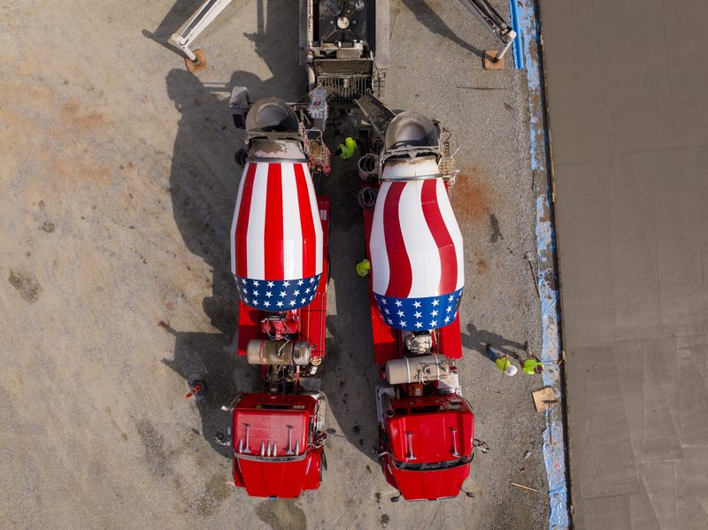 Straight down on two mixer trucks discharging side by side
