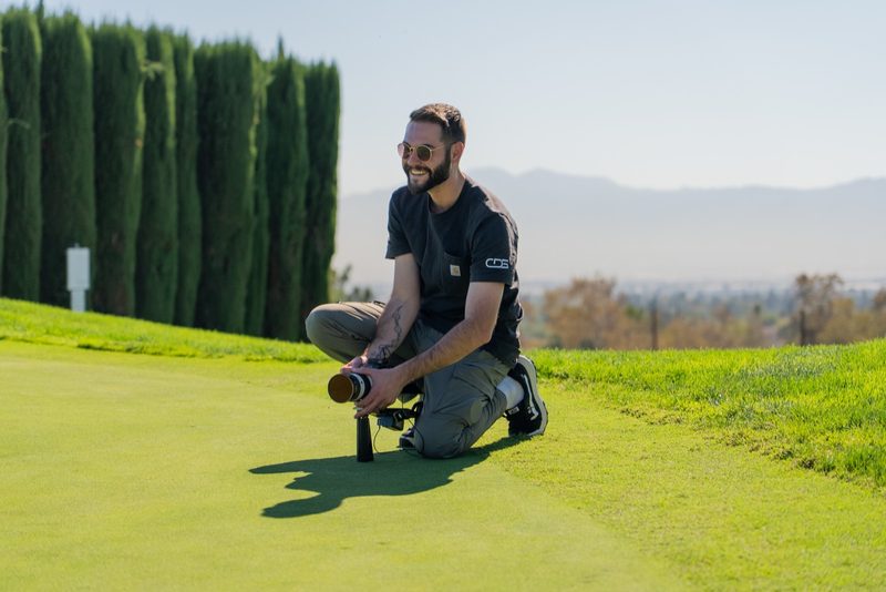 A shooter down low on the green with the mountains behind