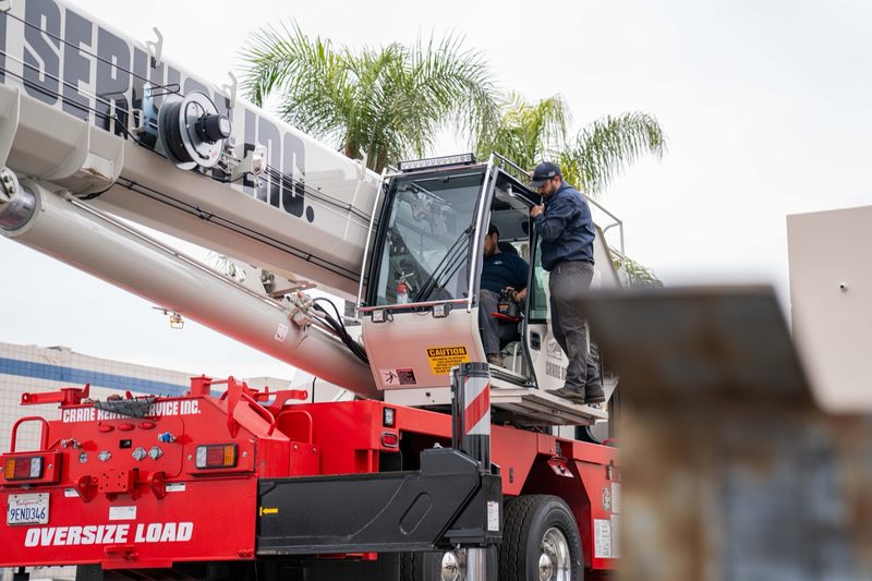 An operator up in the cab of a rough-terrain crane