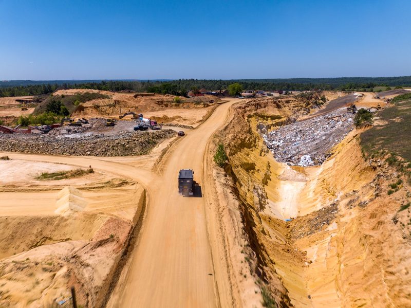 Aerial down the haul road cut through banded earth
