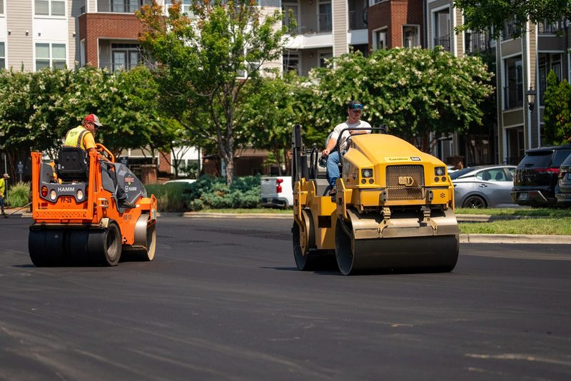 Two rollers following the mat down the apartment drive