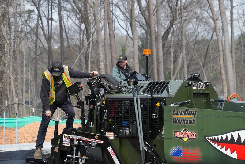 The WarHawk paver working the pull, bare woods behind