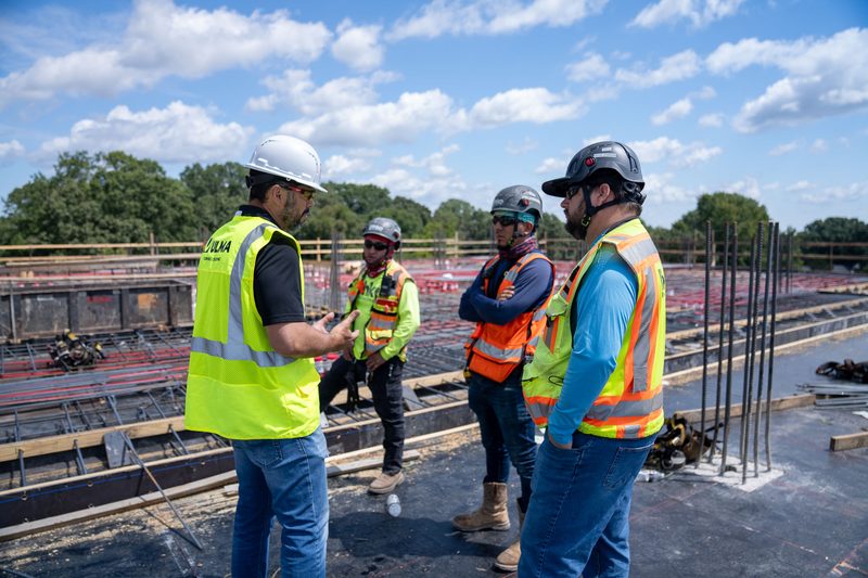 Three of the crew talking it over on the rebar deck