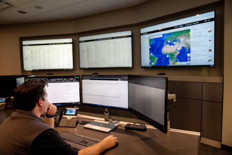 An operator at the monitors in the control room