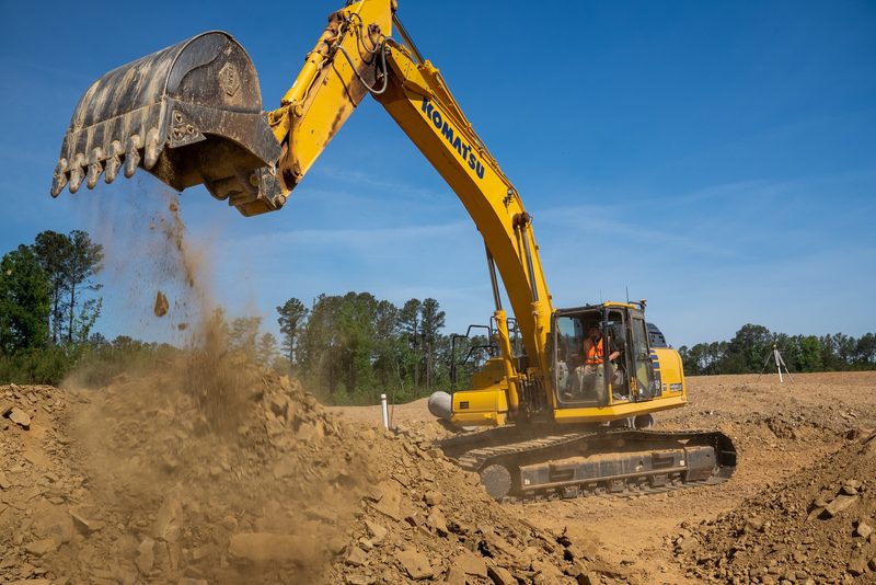 A Komatsu PC360 excavator working, side action frozen mid-swing