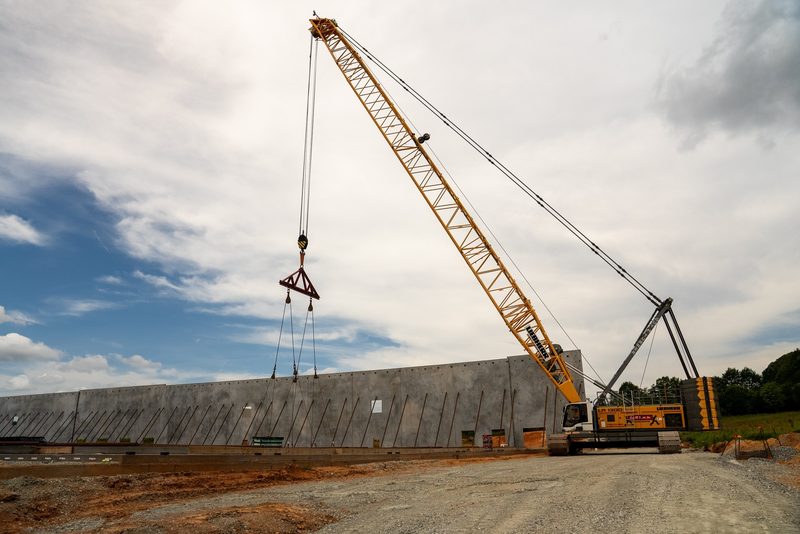 A Liebherr crawler crane, boom rigged, in wide side profile