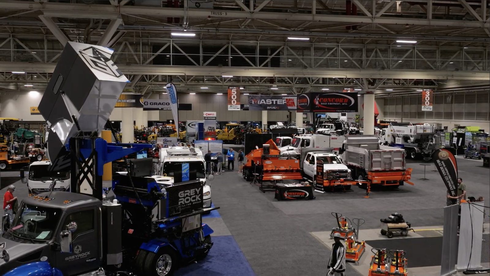 A wide view down the show floor, exhibitor stands and machines set up before the doors open