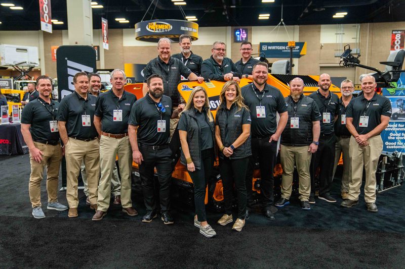 The LeeBoy team lined up in front of the machines on their stand